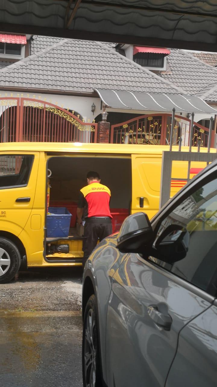 DHL courier collecting parcels
